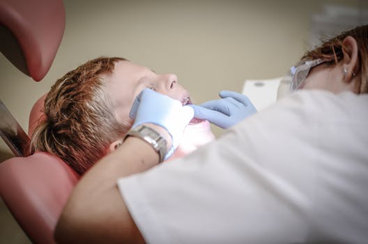 Orthodontist in Glasgow inspecting someones teeth